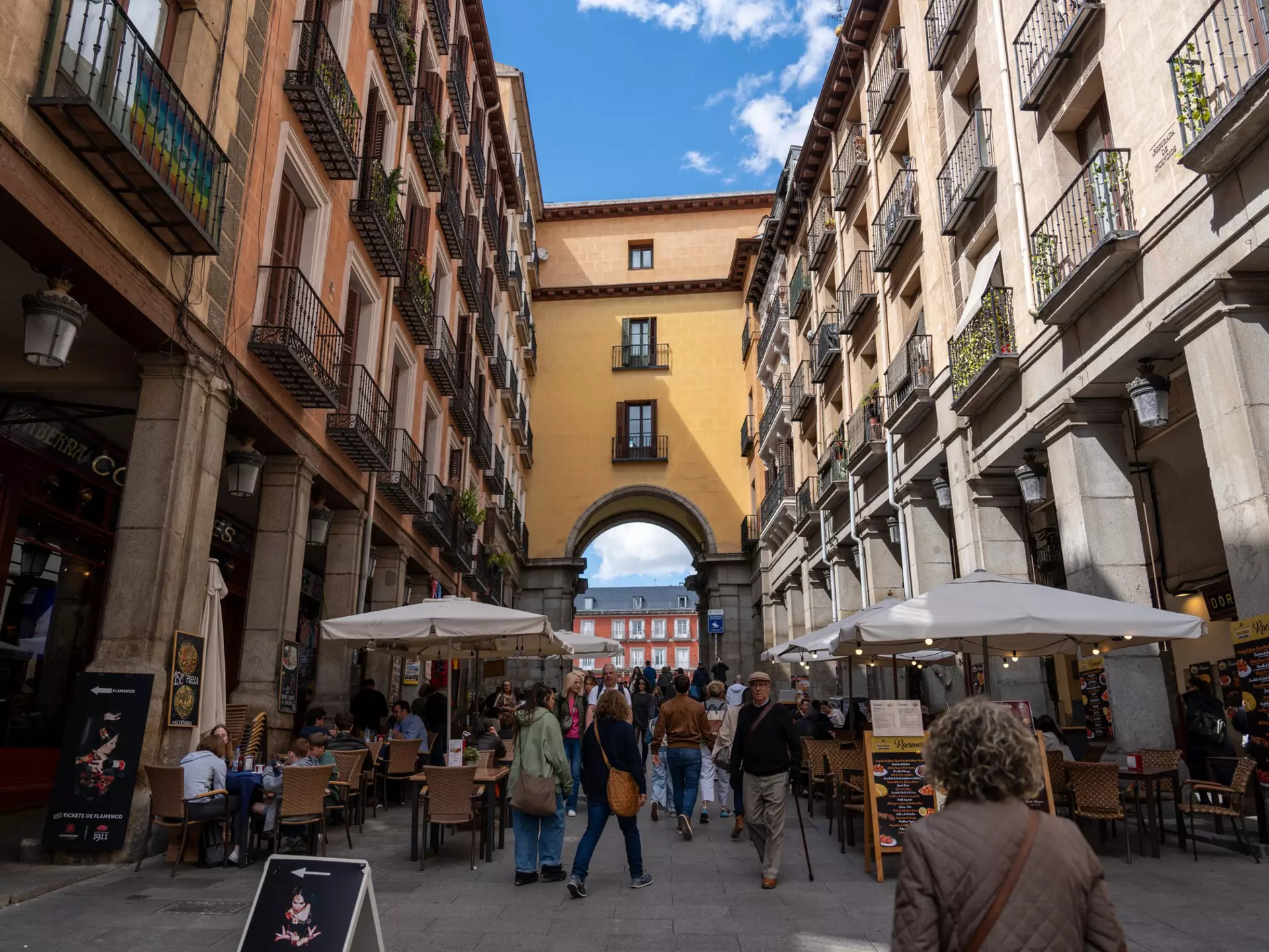 Madrid street with balconies and outdoor cafes
